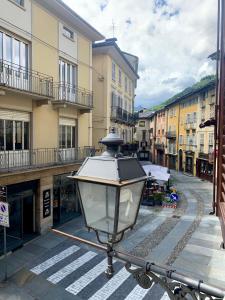 a street light on a city street with buildings at La Lum in Varallo