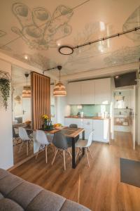 a kitchen and dining room with a table and chairs at RResort Holiday Homes - HEATED Swimming Pool & Sauna in Rewal