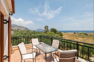 a patio with a table and chairs on a balcony at Agnantio House in Monemvasia