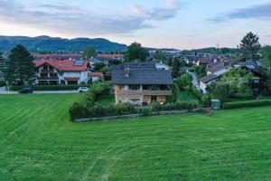 an aerial view of a house in a green field at Dopplerhof's Staufenhaus in Piding