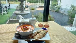 a bowl of soup and some food on a table at Khao thalu guest house in Ban Muang Wan