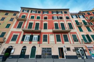 a large red building with a lot of windows at StarFish in Santa Margherita Ligure