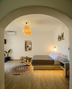 a bedroom with a bed and a rug at Athiri Luxury Suites in Perivolos