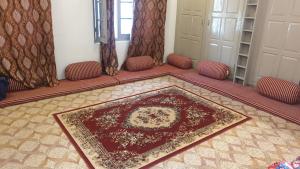 a living room with a rug on the floor at Hanaly Wood Resort & Cafe in Gilgit