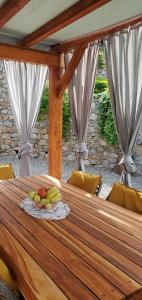 a wooden table with a plate of fruit on it at A Munta di Povei in Casarza Ligure +49 photos