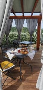a table with a plate of food on a deck at A Munta di Povei in Casarza Ligure