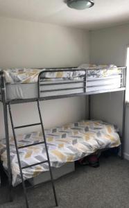 a bedroom with two bunk beds in a room at Cosy Cabin - Bideford Bay Holiday Park in Bideford