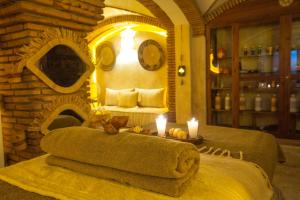 a room with a bed with two candles and towels at Riad Dar L'Oussia & SPA in Essaouira