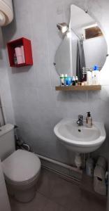 a bathroom with a white toilet and a sink at Studio cozy - Proche Paris, Métro, salles de concert et Disneyland in Montreuil +10 photos