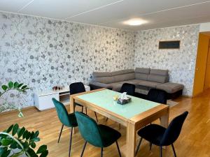 a living room with a couch and a table and chairs at Comfortable apartament to stay in Tallinn in Tallinn