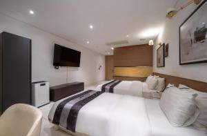 Postel nebo postele na pokoji v ubytování Hotel Cube