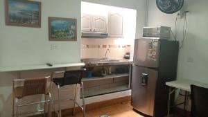 a kitchen with a stainless steel refrigerator and a sink at usoinmobiliario in Medellín