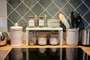 a shelf with jars on it in a kitchen at La casina di mezzo - Tiny House in Camaiore +33 photos