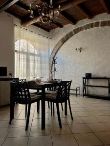 a dining room with a table and two chairs at Il Casalino, casa centro storico in Montefiascone +8 photos