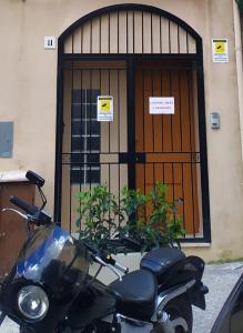 a motorcycle parked in front of a building with a door at GIO&GIO central house in Palermo
