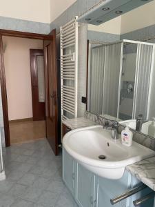 a bathroom with a white sink and a mirror at Torrione view apartment in Spilamberto
