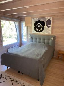 a bedroom with a bed in a room with wooden walls at Pirttiranta in Iitiä