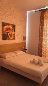 Un pat sau paturi într-o cameră la Hotel Riviera