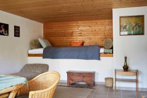 a bedroom with a bed in a wooden wall at Wild Valley Secluded Apartment 1, Valle Onsernone in Loco