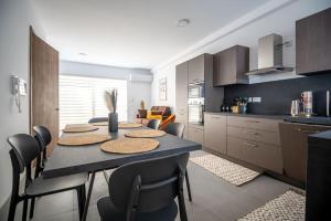 a kitchen with a table and chairs in a kitchen at LA88 Cityway Penthouse in Il-Gżira
