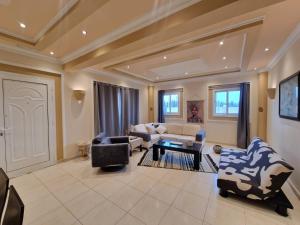a large living room with couches and chairs at Family House in Paphos City