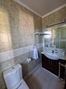 a bathroom with a toilet and a sink at Family House in Paphos City