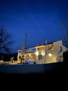 a white house at night with lights on at KAUKABA-Apartamentos Rurales- Adults Only in Pozo Alcón