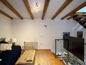 a living room with a couch and a flat screen tv at Kate's Townhouse in Buzet
