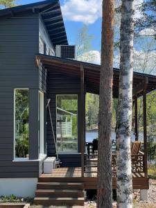 a house with a porch and a deck at Pirttiranta in Iitiä