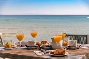 a table with food and glasses of orange juice at Iakinthos, Tsilivi Beach in Tsilivi