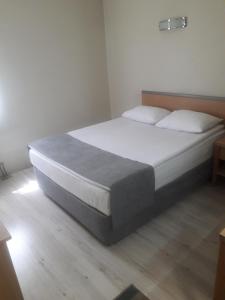 A bed or beds in a room at OTEL AMİLLER