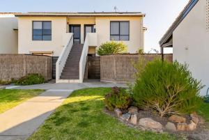 a house with a staircase in a yard at Luxurious 3 bedroom beachfront - panoramic views in Port Adelaide