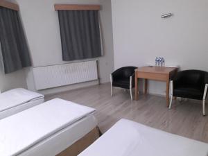 A bed or beds in a room at OTEL AMİLLER