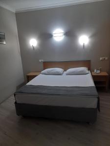 A bed or beds in a room at OTEL AMİLLER