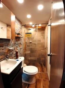 a bathroom with a toilet and a sink and a shower at Glamping Ibanazk in Ibagué