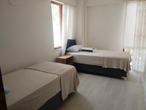 a room with two beds and a window at kadınlar denizi plaji 100 m bahceli havuzlu in Kusadası +19 photos