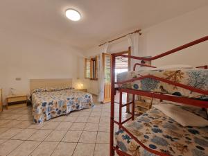 a room with two bunk beds and a staircase at Appartamenti Fetovaia Orchidea in Fetovaia