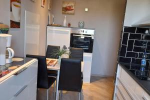 a kitchen with a table and chairs in a kitchen at Ostseenähe in Groß Stieten