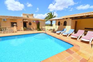 a villa with a swimming pool and patio furniture at Casa Vista Montgo Javea - 5048-2 in Balcon del Mar