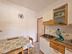 a kitchen with a table and a stove top oven at Appartamenti Fetovaia Elicriso in Fetovaia