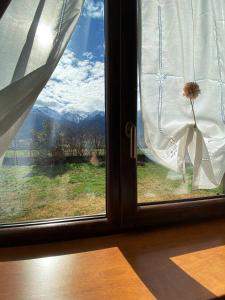 a window with a view of a mountain view at Agriturismo San Giuliano dei fratelli Giai in Susa