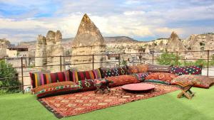 a couch sitting on top of a balcony with a view at Century Cave Hotel in Göreme