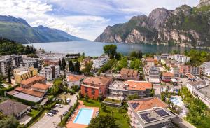 an aerial view of a town with a lake and mountains at Brione Green Resort in Riva del Garda