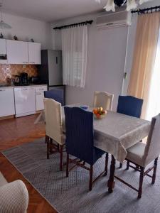 a kitchen and dining room with a table and chairs at Apartman TRALJE in Senj +22 photos