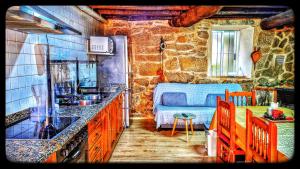 a kitchen with a sink and a bed in a room at Casa Carmen con finca y piscina privada in Cea