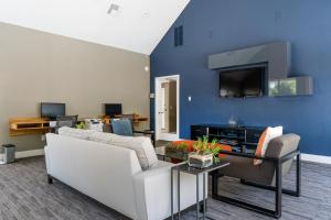 a living room with a couch and a tv at Santa Clara 1BR w Spa Pool AC in downtown SFO-847 in Santa Clara