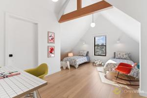 a attic bedroom with two beds and a table at Elegant 3BR House San Francisco in San Francisco
