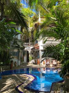 einen Pool im Innenhof eines Gebäudes mit Palmen in der Unterkunft Villa Olde Ceylon in Kandy