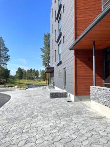 a building with a stone driveway next to a building at Sunny Beach Apartment Hiekkasärkät Kalajoki in Kalajoki