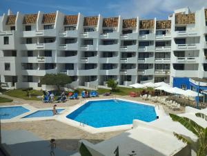 a large apartment building with a large swimming pool at Playa Las Fuentes in Alcossebre